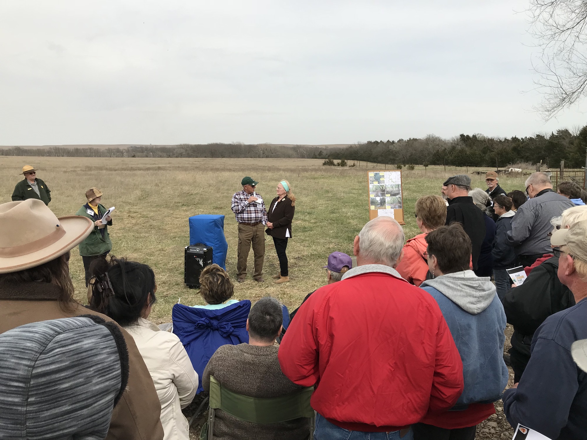 A group of people standing in a field.