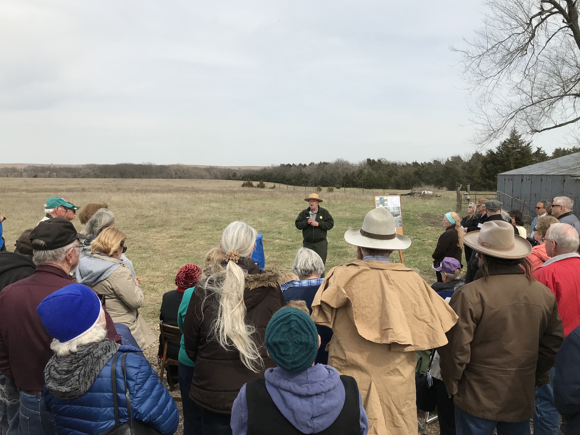 A group of people standing in a field.