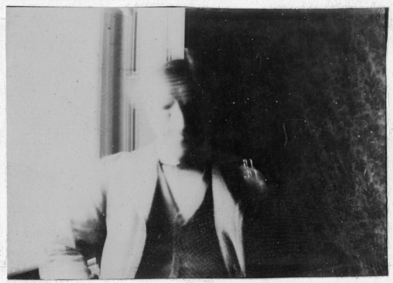 Portrait of elderly man in 3-piece suit. Image is blurry. Face of man can not clearly be seen.