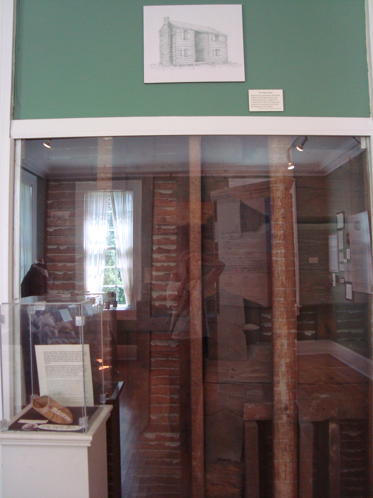 A glass door in a museum setting.
