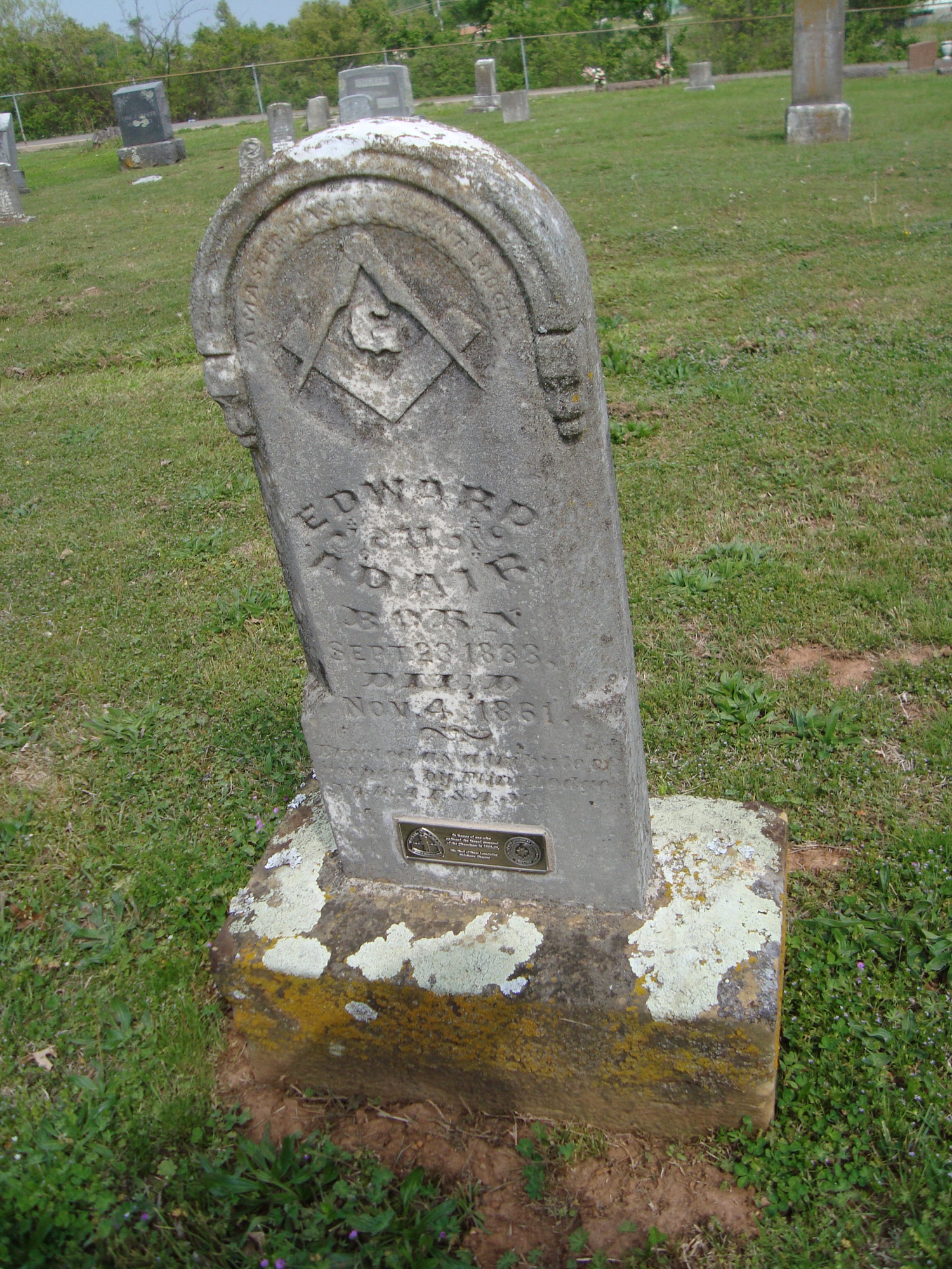 A cemetery with gravestones and trees.