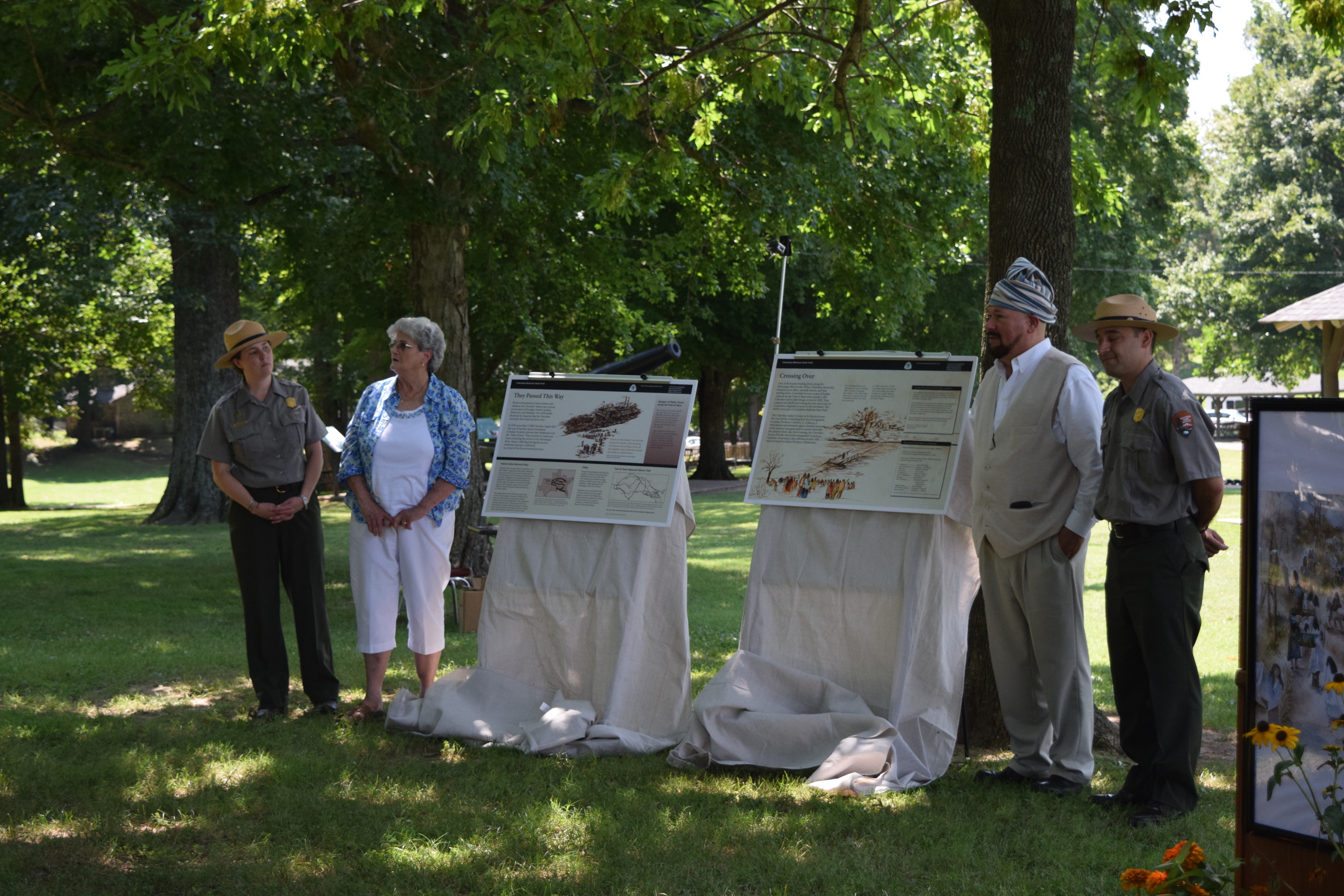 A group of people standing in a park.