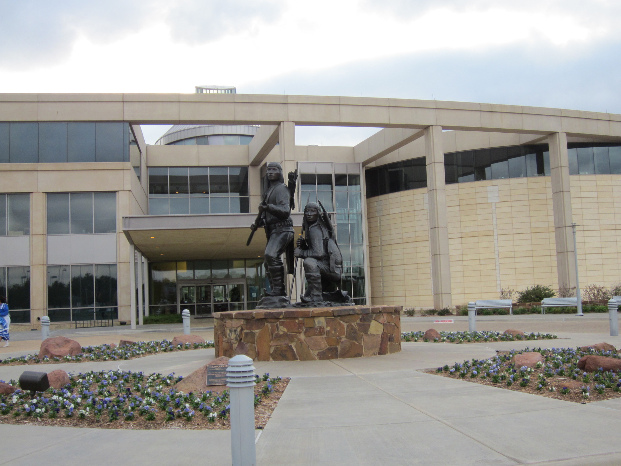A large building with a statue in front of it.