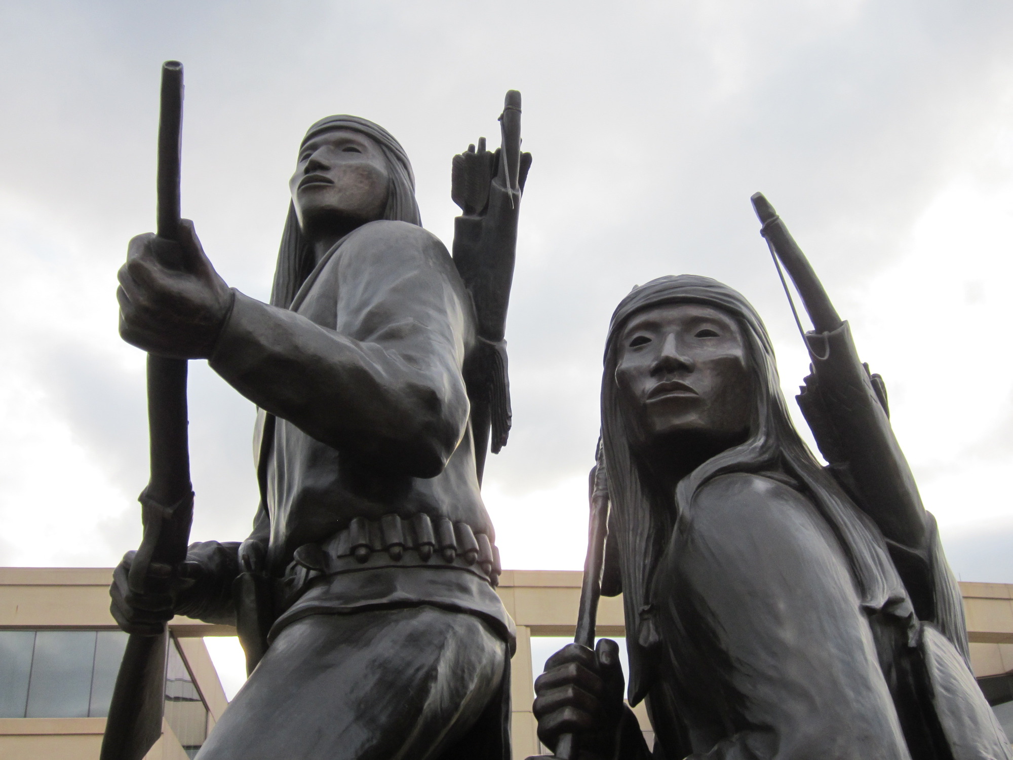 Two statues of men holding rifles.