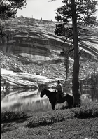 George Goldsworthy on horseback. Beautifully situated lake beneath arches of exfoliated granite.