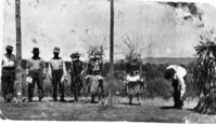 Dance at Stony Ford. Salt Pomo. L to R: Jim Jelfers, George Bill, Jesse Bereyessa, Santiago McDaniels, Louis James, Woody Thatcher, ?, Shoefly (in Moki Cloak). Original in the Craig Bates Collection. Published in "Wealth and Power, Feathered Regalia of Central Calif." by Craig Bates. in Pleasing the Spirits by D. Ewing, Ghylen Press, 1982.