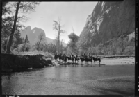 Sailors riding horseback with Cathedral Rocks in background.