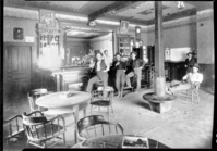 Saloon in old Corcoran House at Mt. Bullion. L-R: Charles Adair (later ranger in Yosemite); John Dunne (saloon-keeper); Bert Raby (next to barkeep); Bussy Hartley; Al Pettis (in corner), George Condrey (sitting) / See note in Fiske bio. file, date November 14, 1936, from Charles and Gerda Adair