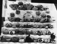 Baskets for sale at Nelson Salter's Yosemite Store, Yosemite Valley. Baskets from the Washoe, Paiute, Yurok, Hupa, and Miwok groups are included. Numbers 10 and 6 by Lucy Telles and are now at the Field Museum of Natural History, Chicago. Numbers 25, 29, & 35 are also by her and are the first documented examples of two color designs, highly refined stitching, flame type patterns and lock lidded baskets from the Yosemite region. #25 in YNP Collection.