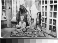 Chief Townsley's daughter, Miss Hazel Townsley & Miss Bertha Dolbow looking over items to be shown at Yosemite's annual Field Days. August 3-4, 1923. Hazel on the left is holding a basket made by Lucy Telles. Copied by Michael Dixon, October 26, 1982.