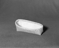 Marie Rozier Collection, Catalog No. CAN-4. Object: Shushwap (Salishan) model cradle. Dimensions: 10 x 4 1/2 x 3". Materials: Birchbark, unidentified root and shoot. Technology: "SHUSWAP LAKE" burned into side, "INTERIOR SALISH INDIAN SALMON ARM B.C." burned into bottom. Collection History: Purchased in Salmon Arm, B.C., 1969. Photographed by Michael Dixon, December 1982. Catalogued by Craig Bates and Barbara Beroza. Yosemite Collections, National Park Service.