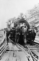 Old building Road Scene during construction of Exchequer Dam. L to rt. Wm. Shaj Hubert McHugh, Wm. Cobb, Melvin Williams.