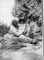 Lucy Brown surrounded by basket materials and Great Granddaughter Alice Roosevelt Wilson in a Miwok cradleboard. (Fig. 262, p. 140 Traditions & Innovations).