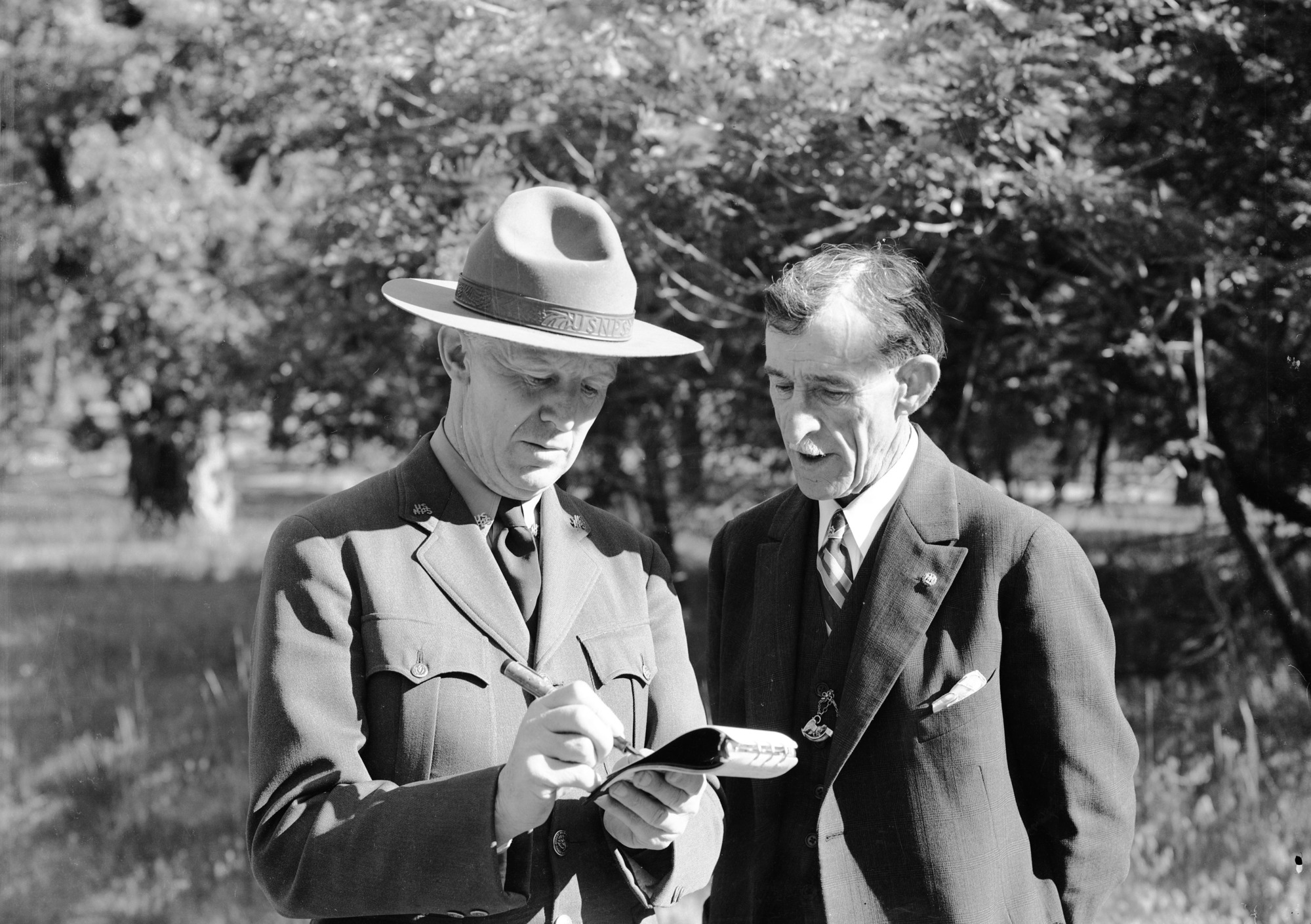 Park Naturalist Harwell interviewing Chas. Leidig, first white boy born in Yosemite.