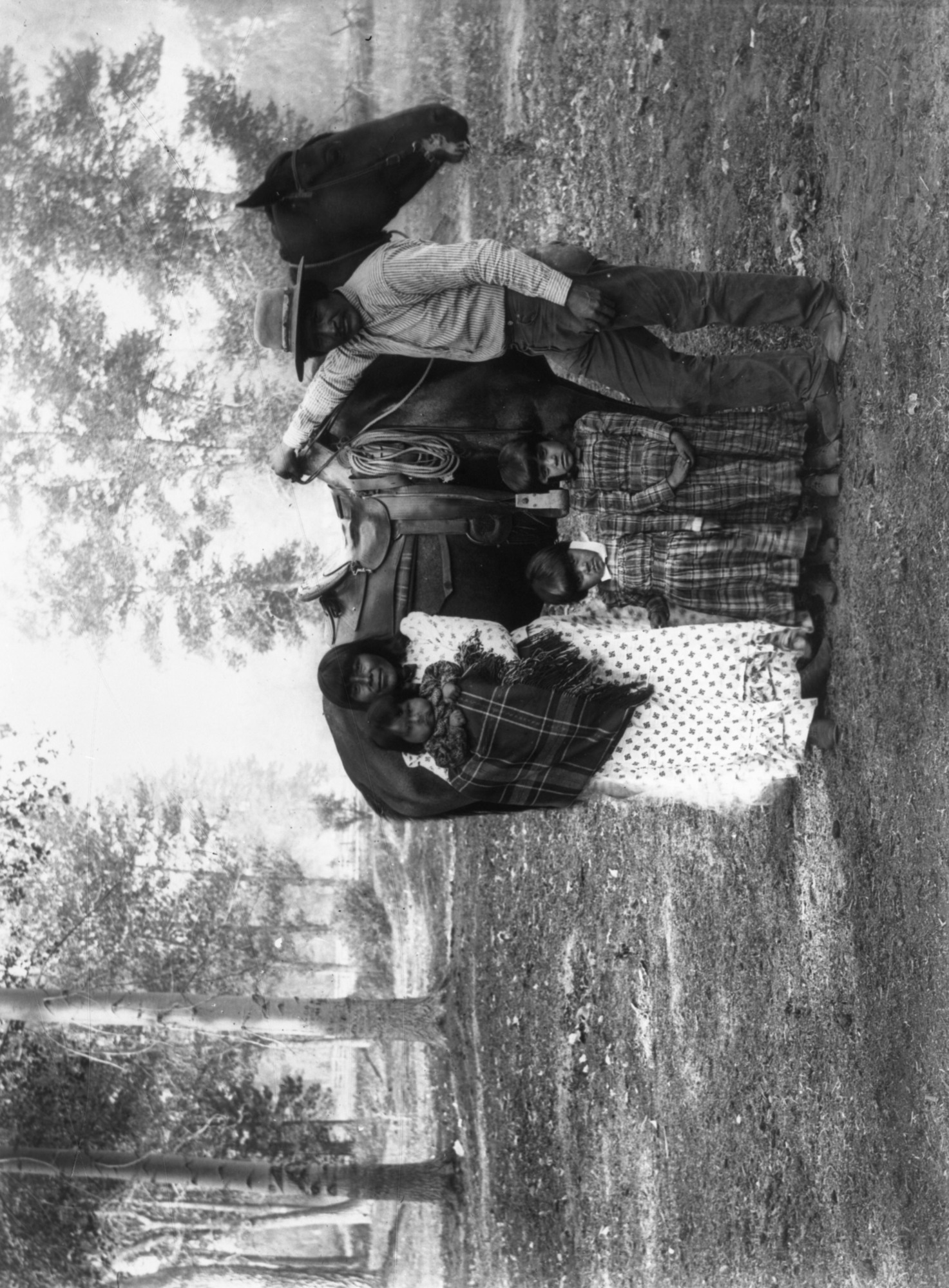 Copy Neg: 1985, M. Dixon. Paiutes in Yosemite Valley. Original in YNP collection. Labelled as "Paiute Bill". Written on neg. envelope: "Piutes from Mona (sic) Lake: in Yosemite Valley for acorns. Stay 3 or 4 weeks and gather several bushels & go out over the Yosemite Falls trail. Mona Lake 40 mils? (sic) distant in Nevada?" YM-27,028 (glass plate); YM-27,262 (film transparency); Suzie McGowan with Saddie (baby), Carrie (Left) and Minnie - Dean Tonenna 8/7/2014