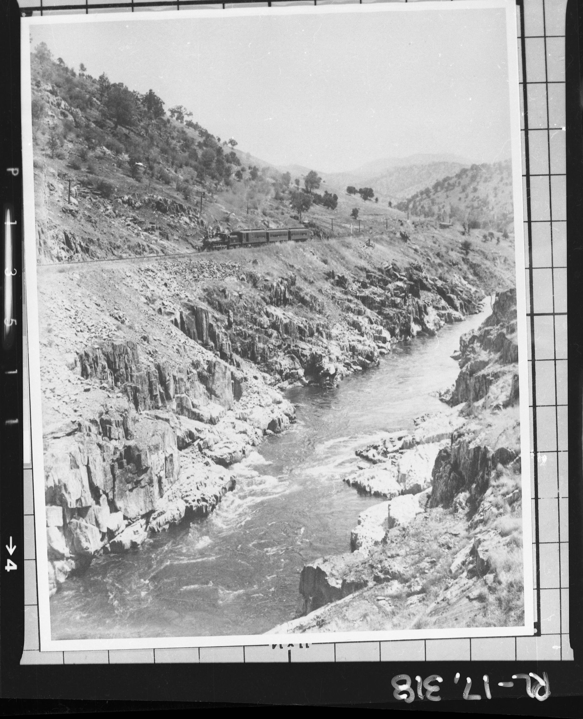 Copy Neg: J. Ernest, 1983. No. 21 pulling 3 car passenger train through Box Canyon in June, 1907. (Printed in Hank Johnston's Short Line to Paradise). Original print in the over-sized photo drawer in RL.