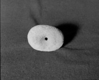 Marie Rozier Collection, Catalog No. 29. Object: Arrow straightener. Dimensions: 4 1/2". Materials: Granitic (?) cobble, stained red by soil. Collection History: Gift of Dottie McDow, found somewhere in Tuolumne County. Photographed by Michael Dixon in December 1982. Catalogued by Craig Bates and Barbara Beroza. Yosemite Collections, National Park Service.