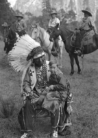 Chris Brown at 1929 Indian Field Days with child on knee.