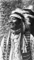 Chris Brown, "Chief Lemee." Plains style war bonnet he wears is in the YNP Collection.
