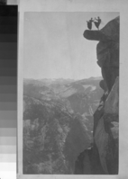 Copy Neg: 1985 by Michael Dixon; "Dancers on Overhanging Rock Rock at Glacier Point" Kitty Tatch and Katherine "Kitty" Hazelstine or Hazelston in a high knee kick dance on top of Rock. *Additional "best" neg in Mary Vocelka's file on Two Ladies. Neg. #18,194 for other view- not on card yet.