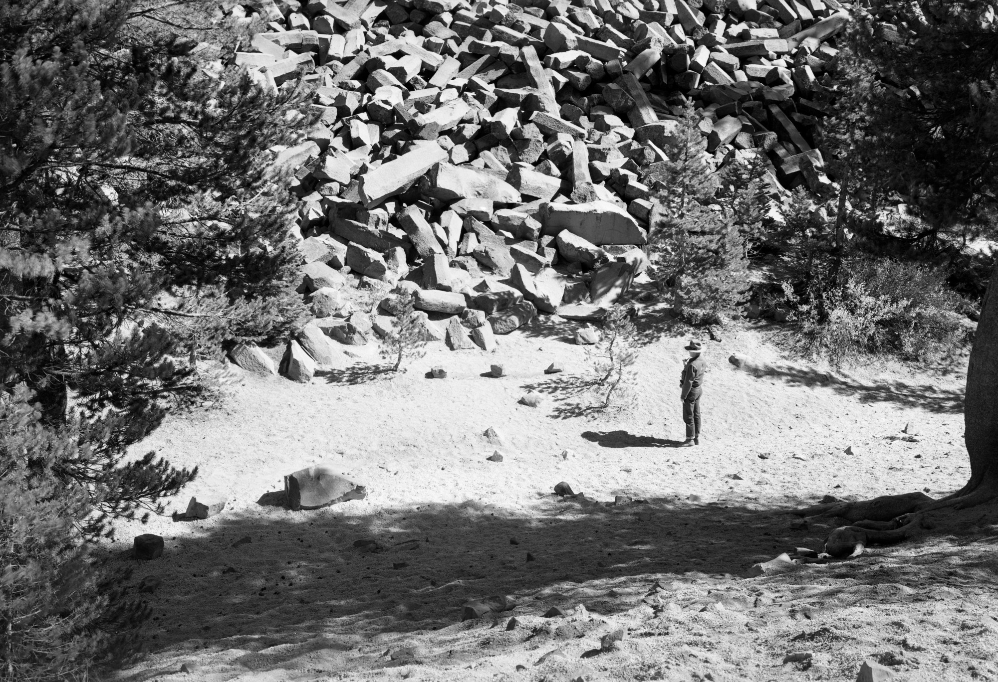 Closeup of talus of broken posts with Ranger Jacobs.