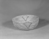 Private Collection. Object: Miwok basket. Dimensions: 7 1/2 x 3 1/4". Materials: Bull pine, redbud, & fern root. Technology: Single rod, fag ends trimmed on work face, moving ends trimmed on interior. Leftward coil direction, rim overstitched. Lower part of design in fern root and upper part in redbud. Overstitched clockspring. Collection History: Made by Matilda, a Sonora Miwok, c. 1920. Photographed by Michael Dixon. Catalogued by Craig Bates and Barbara Beroza. Yosemite Collections, National Park Service.