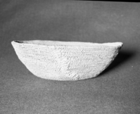 Mrs. Geraldine McConnel Collection. Object: Miwok basket. Dimensions: 9 1/2" x 3". Materials: Scrapped shoots, split bull pine branchlets. Technology: Single rod: interlocking stitch, clockspring start. Heavy repair on each side in the same material. Collection History: From a member of Mrs. McConnell's family that lived in Sonora. Thought to have been acquired from a Miwok woman in Sonora probably c. 1900. Photographed by Michael Dixon in January 1983. Catalogued by Craig Bates and Barbara Beroza. Yosemite Collections, National Park Service.
