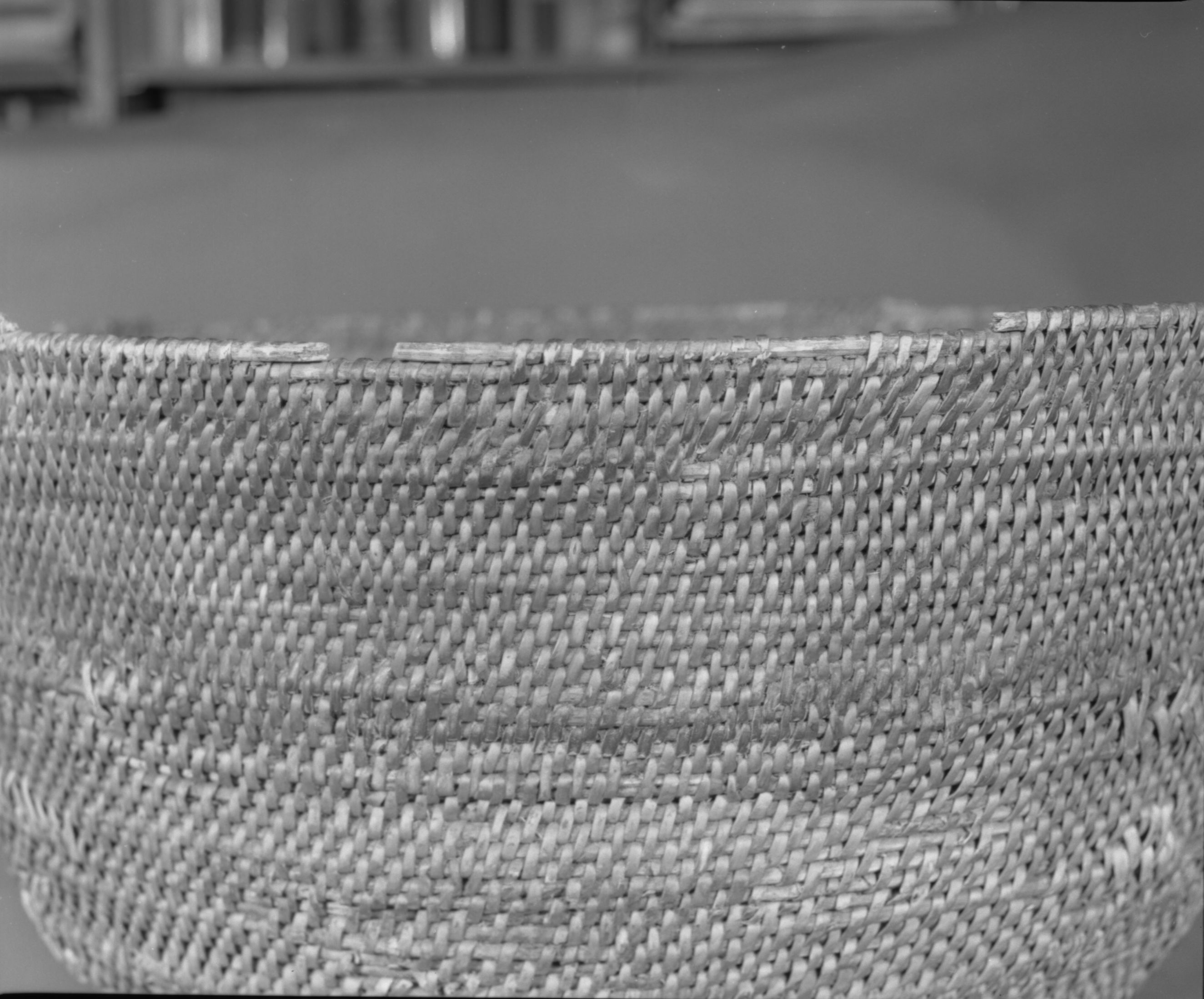 Private Collection. Object: Miwok basket. Dimensions: 18 x 10". Materials: Redbud and split willow shoots in original basket. Repairs in split maple shoots. Technology: Original basket is single rod, interlocking stitch, leftward coil direction. Repair begun on base of old basket and worked toward center until center 3 1/4", when clockspring start was stitched in to fill remainder two rows of coiling with two sewing strands at the same time, one redbud & one willow, near upper edge of original basket. Collection History: Collected by owner's mother. Murphys 1915. Photographed by Michael Dixon. Catalogued by Craig Bates and Barbara Beroza. Yosemite Collections, National Park Service.