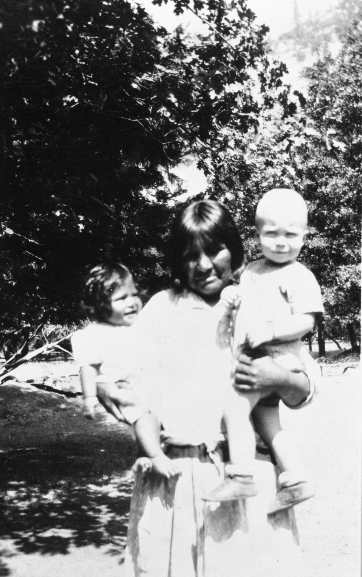 Mrs. Bridgeport Tom (Paiute Native American) holding her grandchild "Lucile", five months old (right). She was very anxious to get a picture of "the white baby" and felt very proud to have her picture taken holding George Phinney (Jack's brother)