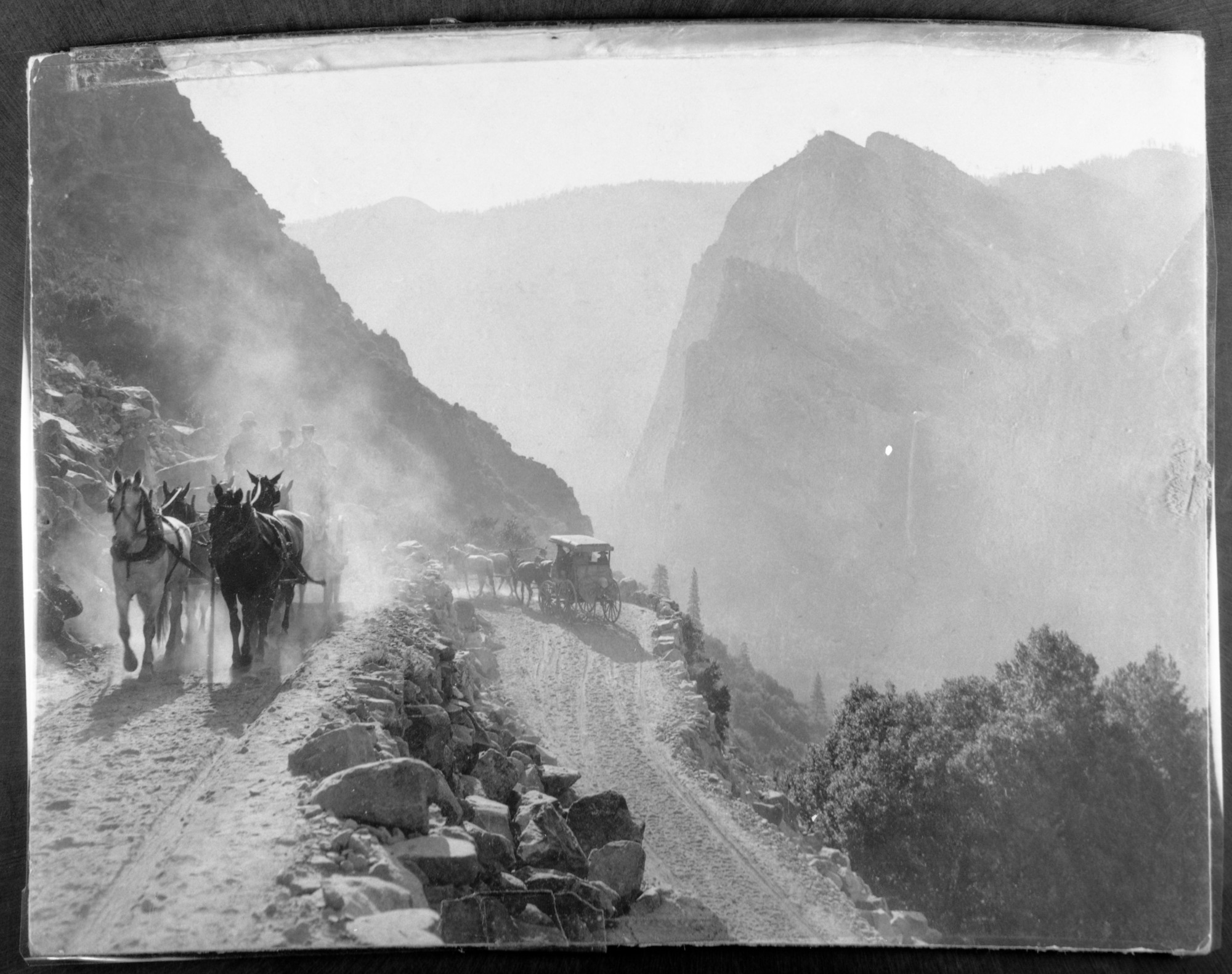 Four horse and six horse wagons on the Big Oak Flat Road on the zigzags above Yosemite Valley.