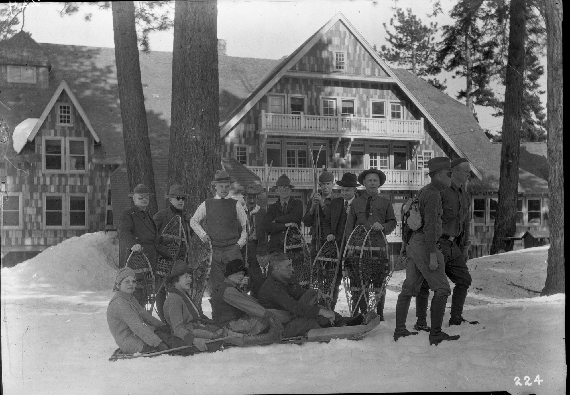 Group of snowshoers at Glacier Point Hotel is in the background