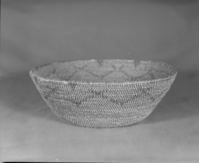 Private Collection. Object: Miwok basket. Dimensions: 12 x 4 1/2". Materials: Bull pine and redbud. Technology: Single rod, fag ends trimmed on work face, moving ends trimmed on interior. Leftward coil direction. Rim overstitched three times. Overstitched clockspring start. Large clockspring ca. 3/4". Collection History: Made by Matilda, a Sonora Miwok, c. 1920. Photographed by Michael Dixon. Catalogued by Craig Bates and Barbara Beroza. Yosemite Collections, National Park Service.
