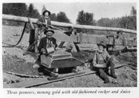 Three pioneers, mining gold with old-fashioned rocker and sluice.