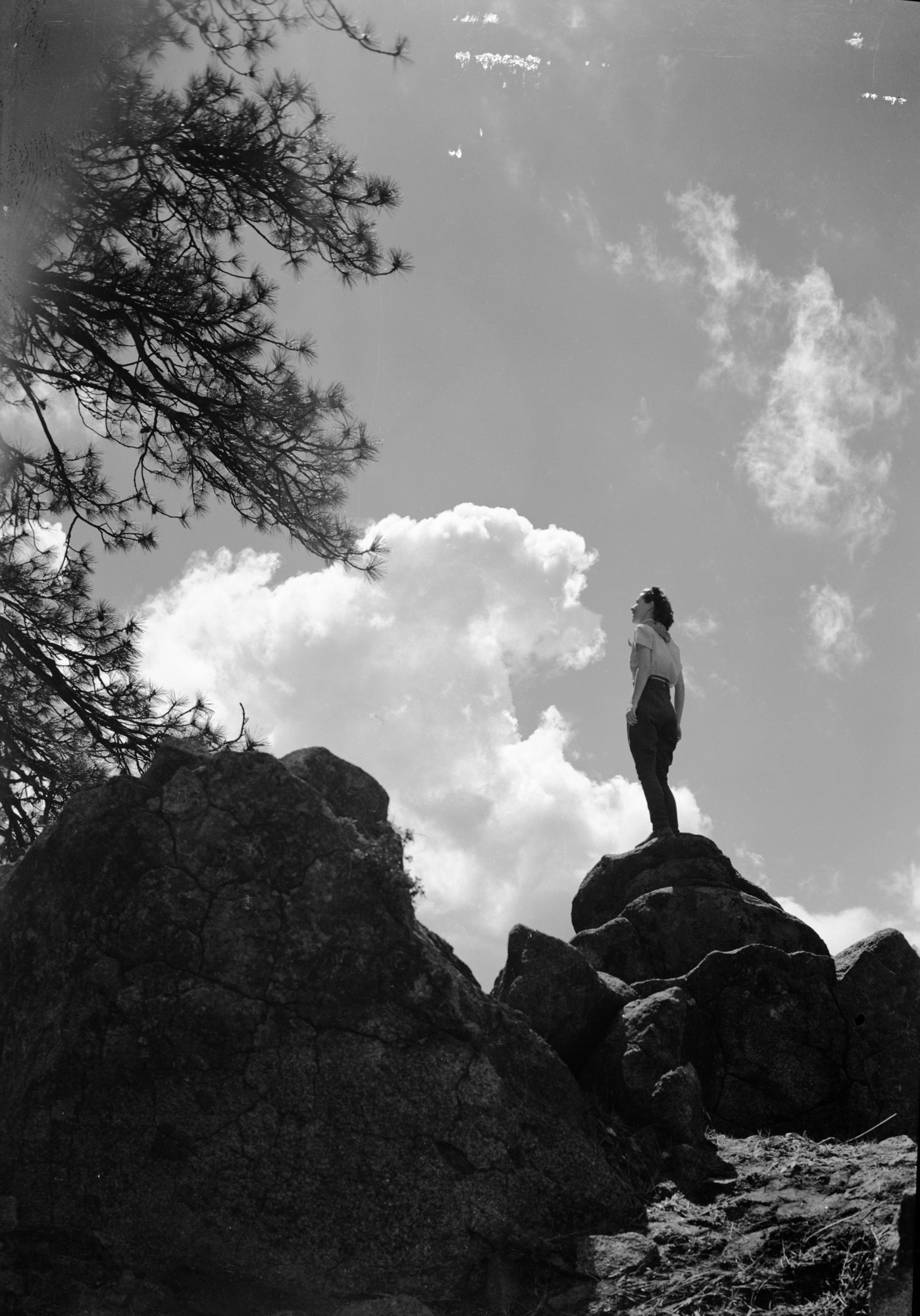 Girl on cloudy skyline
