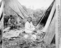 Watkins' Pacific Coast. Copy Neg: M.D. 7/24/85. Detail of L. Smaus stereo (RL-16,589). Caption: "At the Rancherio, Mendocin County, California." Woman weaving basket; boy holding bow and arrow. Acorns in bag between them, probably drying.
