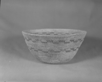 Private Collection. Object: Miwok basket. Dimensions: 11 x 5 1/4". Materials: Bracken fern root, split maple shoots (?). Technology: Single rod, interlocking stitch, rim finish by one additional row stitching clockspring start plugged with cloth knot. Inside blackened from use as cooking vessel. Collection History: Purchased from Maggie Longfellow's mother, also known as Mrs. Longfellow Poncho. Photographed by Michael Dixon. Catalogued by Craig Bates and Barbara Beroza. Yosemite Collections, National Park Service.