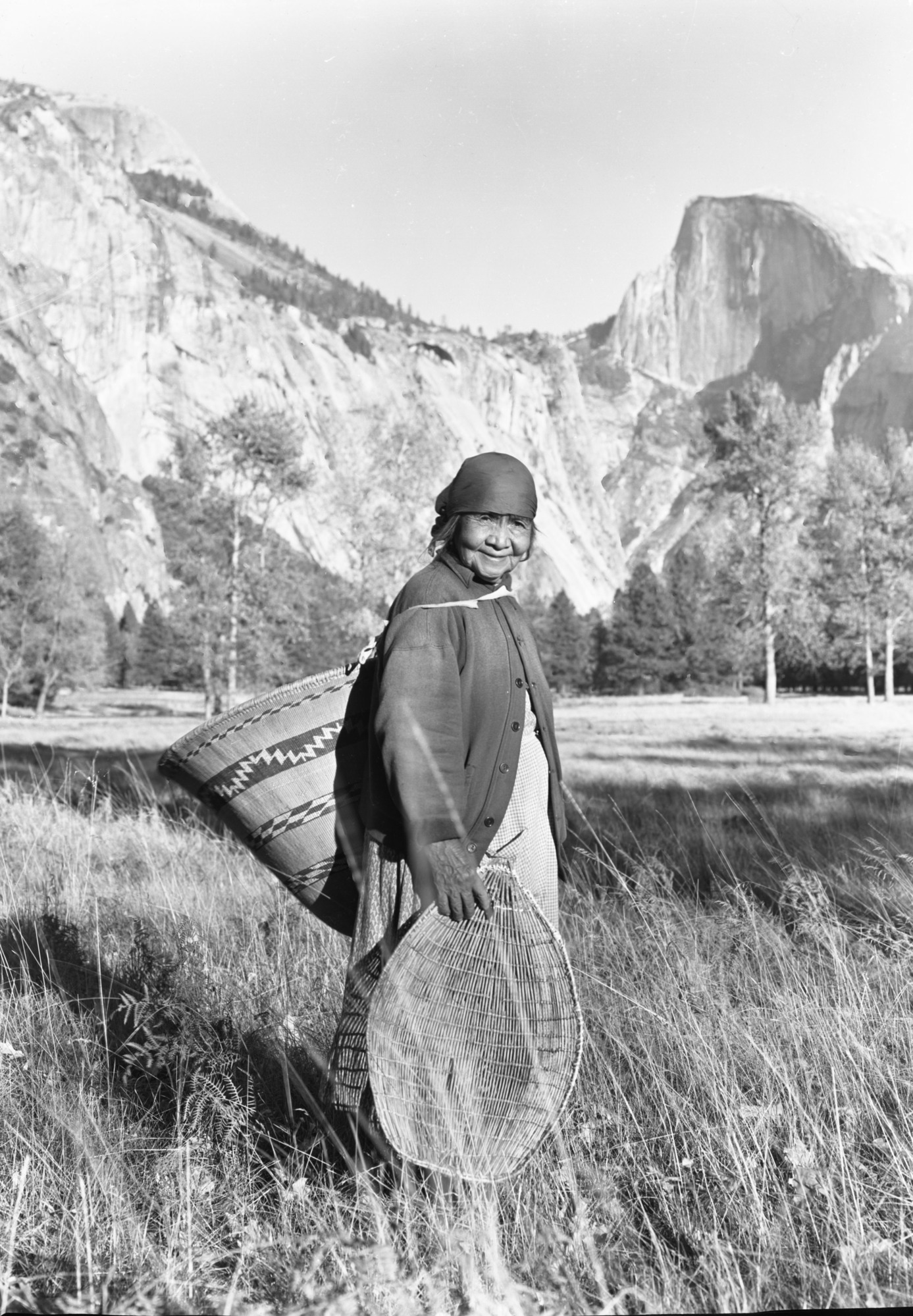 Ta-buce out gathering acorns and grass seeds, Ahwahnee Mdw. 1930's (?)