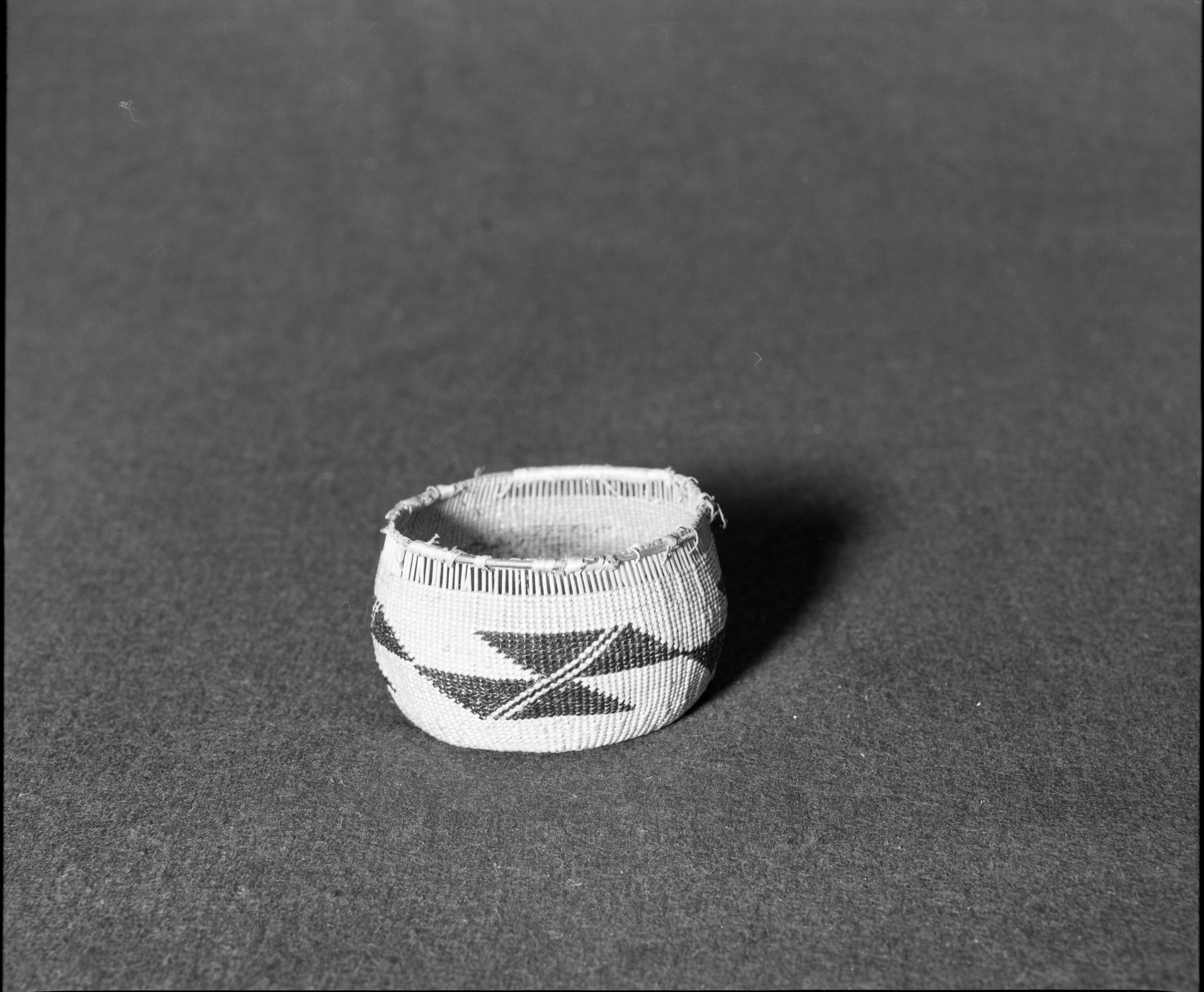 Marie Rozier Collection, Catalog No. 124. Object: Yurok/Karok/Hupa basket. Dimensions: 2 1/2 x 3-1/8". Materials: Hazel, conifer root, beargrass, maidenhair fern stem. Technology: Three strand twining, diagonal twining used on start. Collection History: Gift of Ora Doyle. Photographed by Michael Dixon in December 1982. Catalogued by Craig Bates and Barbara Beroza. Yosemite Collections, National Park Service.