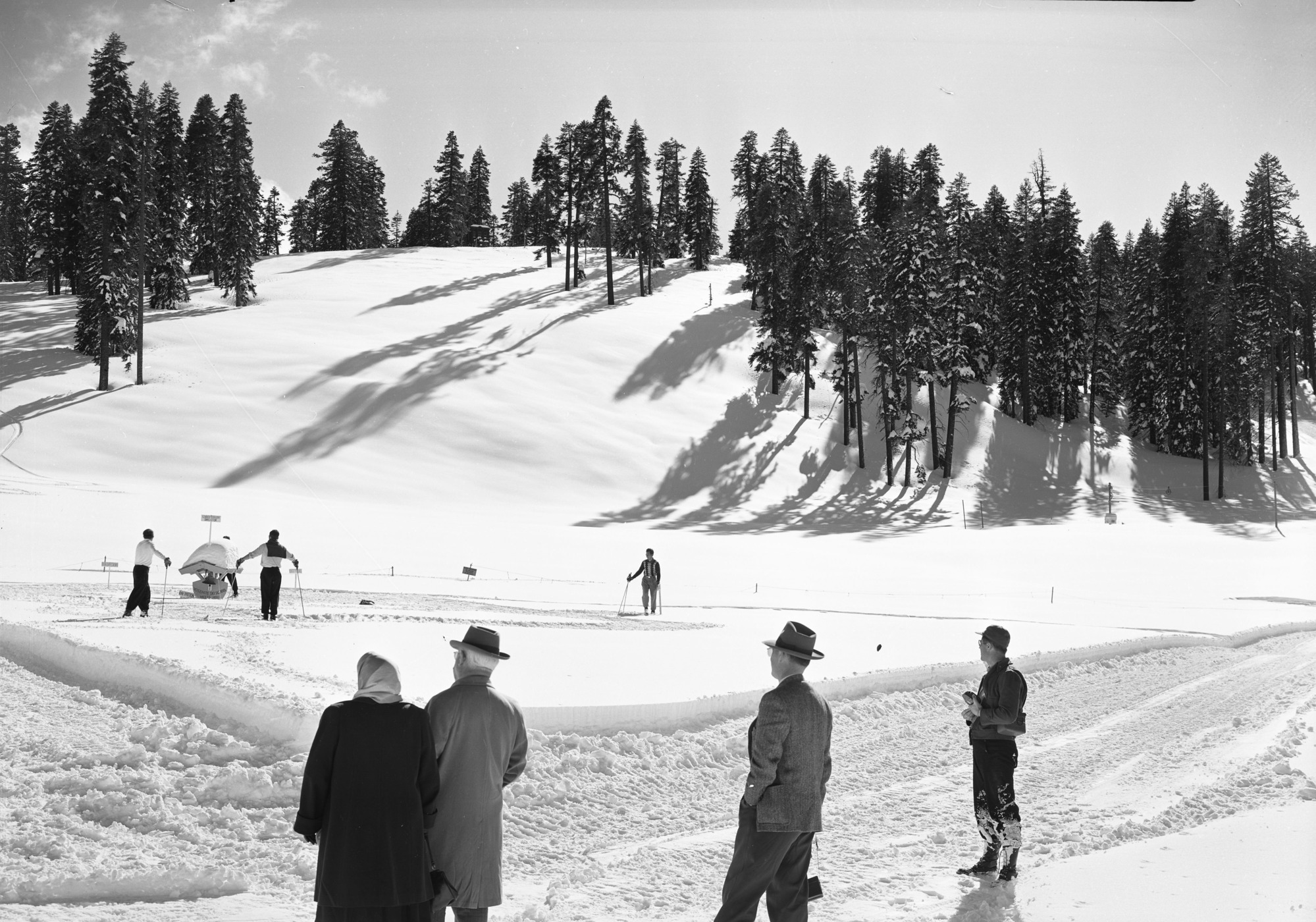 After record snowfall. In pictures are Mr. and Mrs. Arthur Demaray, recently retired Director of NPS; Mr. and Mrs. Wesley, landscape engineer of Region Four; Supt. Carl P. Russell; Ranger John Mahoney; E. C. Smith, park engineer; District Ranger buck Evans and his daughter Jeanie.