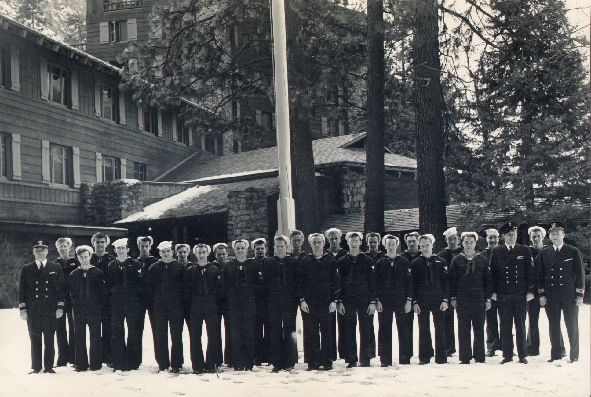 Twenty four uniformed navalmen and three officers standing in front of the Ahwahnee