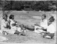 Playing hand game in Yosemite Valley. L to R: Sally Ann (South. Miwok), Maggie Howard (Mono Lake Paiute), Grace Anker (S. Miwok), & Bill Tadd (Cen. Miwok).