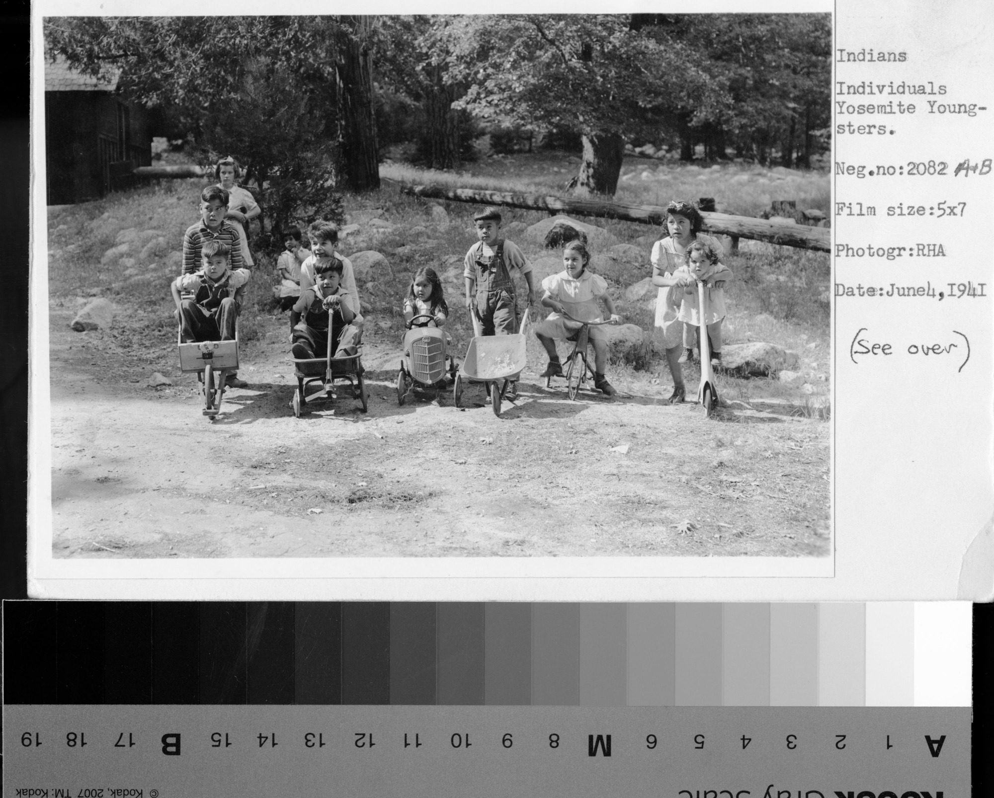 L to R: 1) in wheelbarrow unidentified - Joe Rhoan 2) Jay Johnson 3) Evelyn Brochini Wilson 4) Unidentified 5) Burleigh Johnson (front) 6) Carl Dondero, Joan Rust (standing in back) 7) Unidentified - Beatrice Rhoan 8) Charlie Castro 9) Barbara Bertocini 10) Patricia Castro 11) Roberta Castro -NO Charlie Castro says this is Punky Beverly Rust (Hippsman); Log in background is boundary for Indian Village/Camp 4