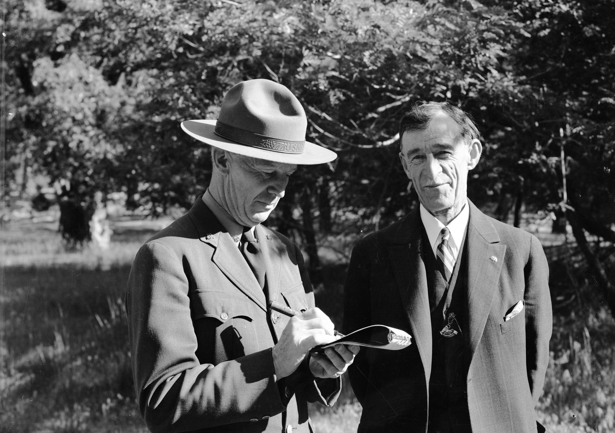 Park Naturalist Harwell interviewing Chas. Leidig, first white boy born in Yosemite.