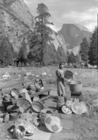 Copy Neg: L. Radanovich, 3/98. Cleaning baskets back of Museum. Showing part of the fine collection of Indian basketry in Yosemite Museum. Photographer: Taras (Civil Works Administration)