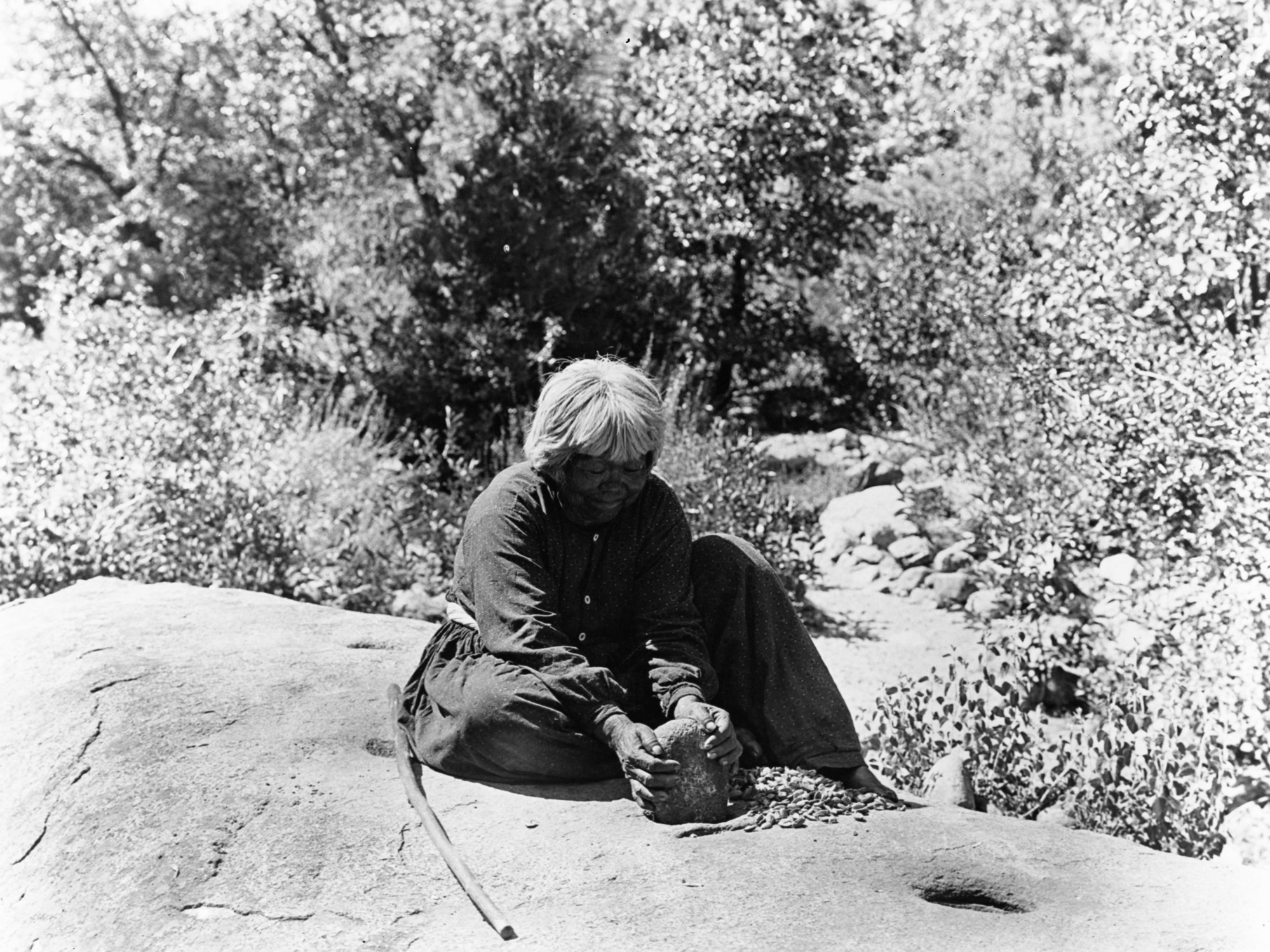 Old Lucy (Lucy Brown) pounding acorn.