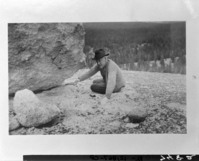 Stephen T. Mather at Tuolumne Meadows, Yosemite. Looking at a glacial erratic on the polished granite of Lembert Dome.