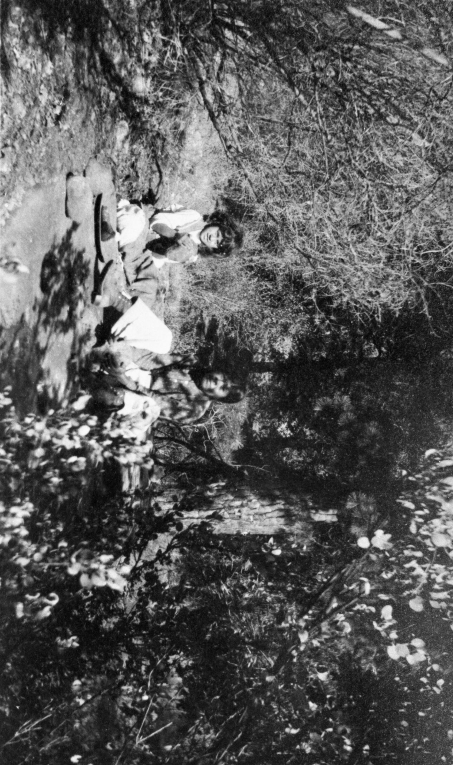 Copy Neg: 1985 by Michael Dixon. Suzie Georgely & daughter pounding acorns in Yosemite Valley. Suzie, wife of Francisco Georgely, was Chukchansi. Original in YNP Collections (Part of the Matthes collection). Photographer: Miss Ora Bearing (possibly Boring/Boreing, the school teacher)