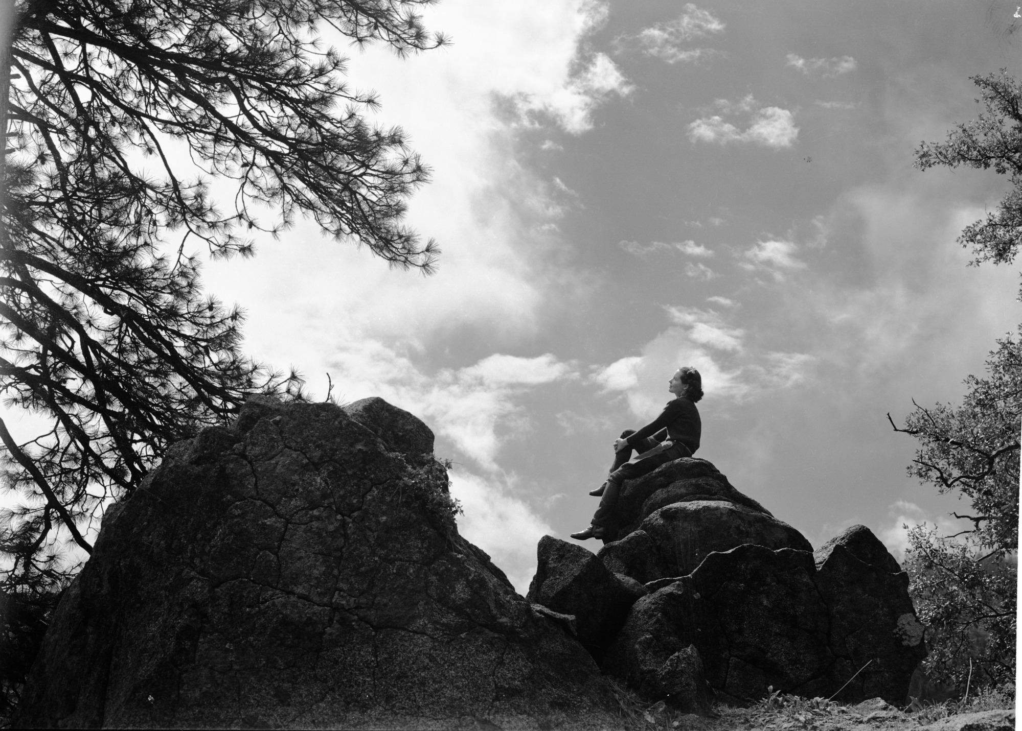 Girl on cloudy skyline