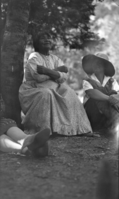 Playing handgame--her arms are crossed to hide the bones.