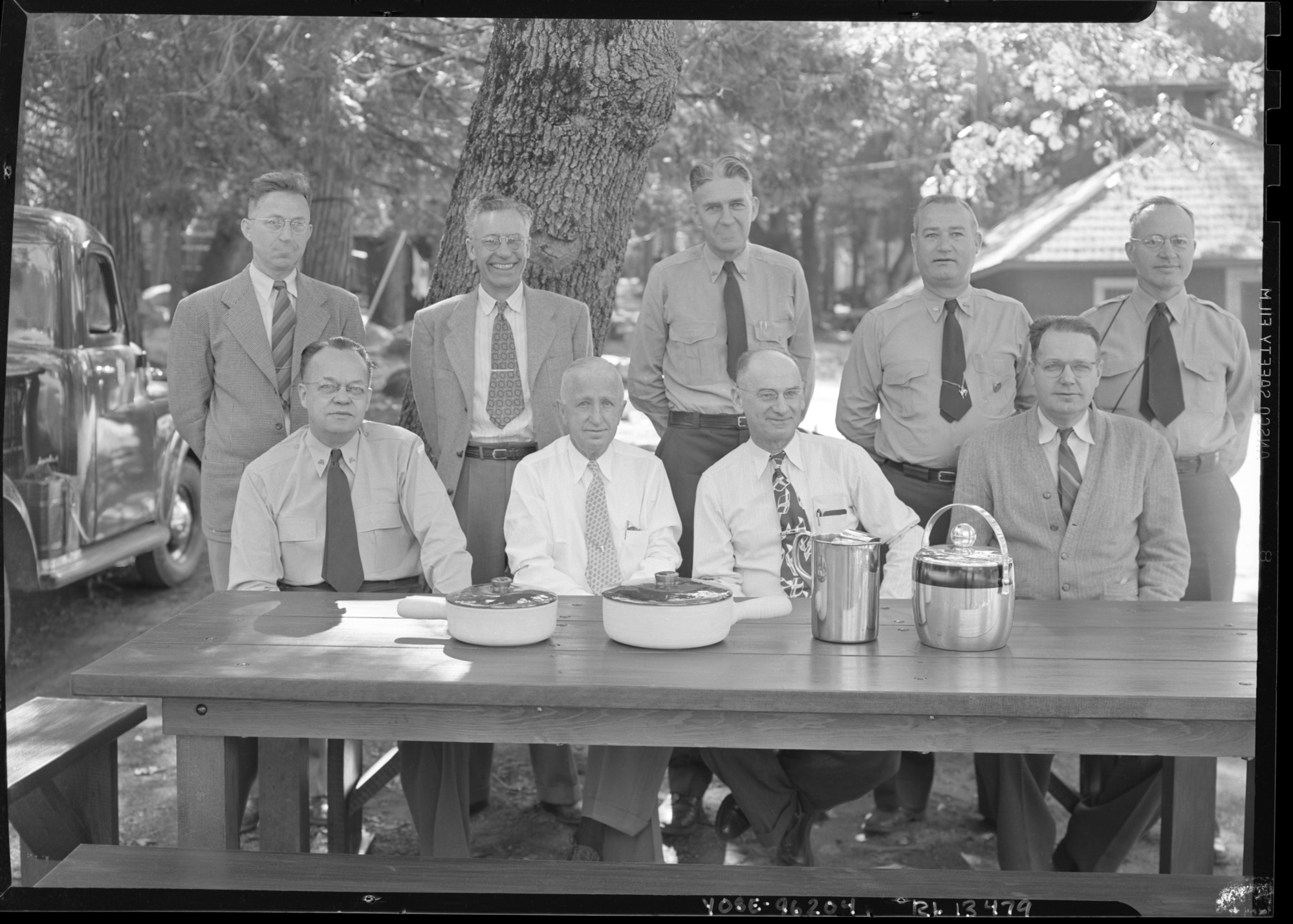 Members of Park Staff on occasion of Frank B. Ewing's retirement. Behind table (L to R): Carl P. Russell, Frank B. Ewing, William J. Ellis, and Emil F. Ernst. Standing: E. Carlton Smith, Charles F. Hill, Oscar A. Sedergren, John B. Wosky, and Ralph H. Anderson.